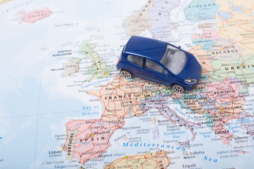 Blue model car on a map of Europe