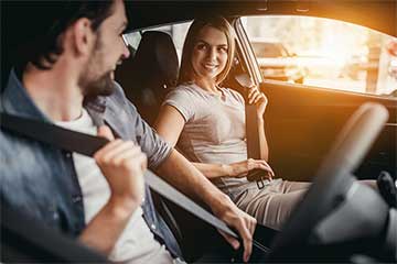 Two drivers belting up before driving