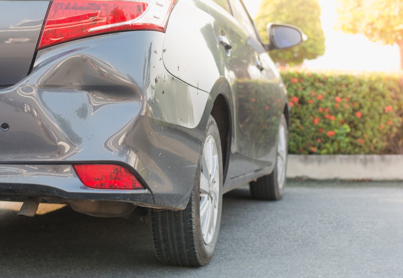 Car with a dented rear after being hit by an uninsured driver