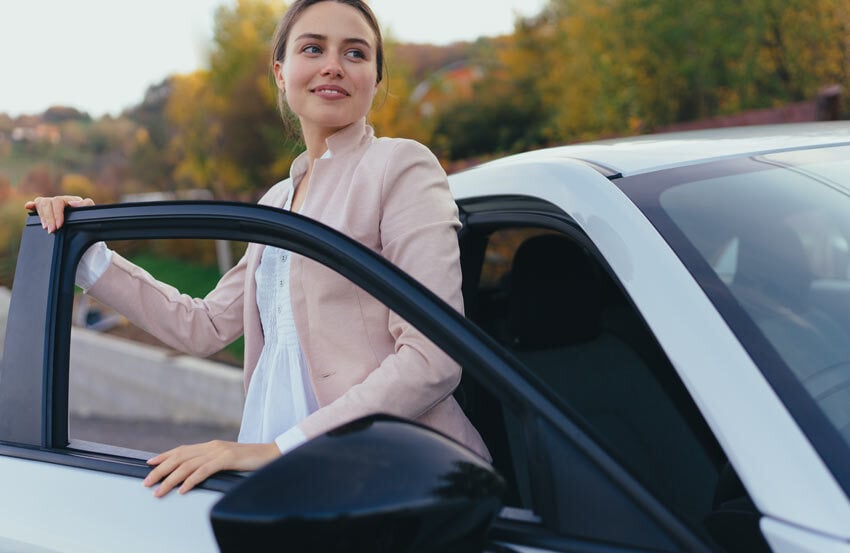 Woman stepping out of a car