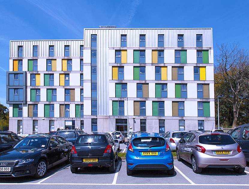 Cars parked infront of a university