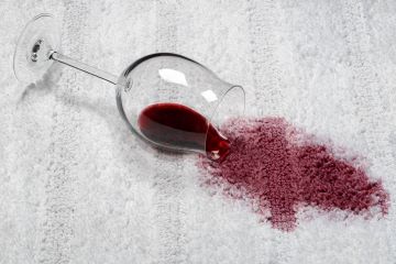 Red wine spilled on a white carpet