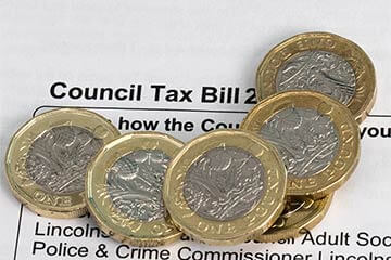 A row of coins on a council tax bill