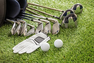 Golf equipment laid out on a lawn