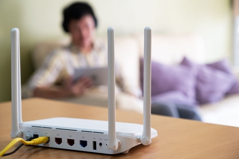 Wi-Fi router on table with man in the background