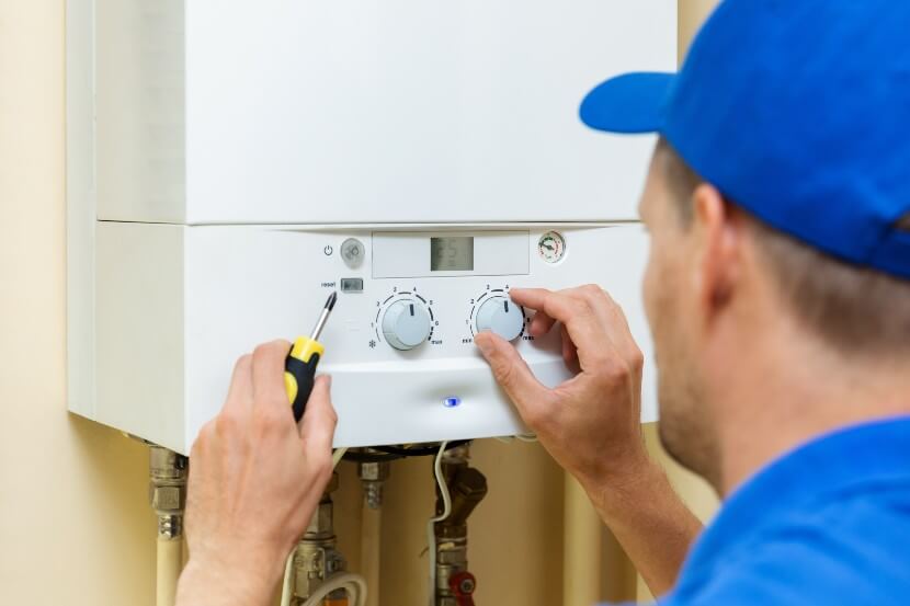 Engineer installs a combi gas boiler