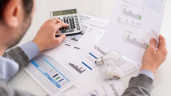 Man calculating VAT on business energy