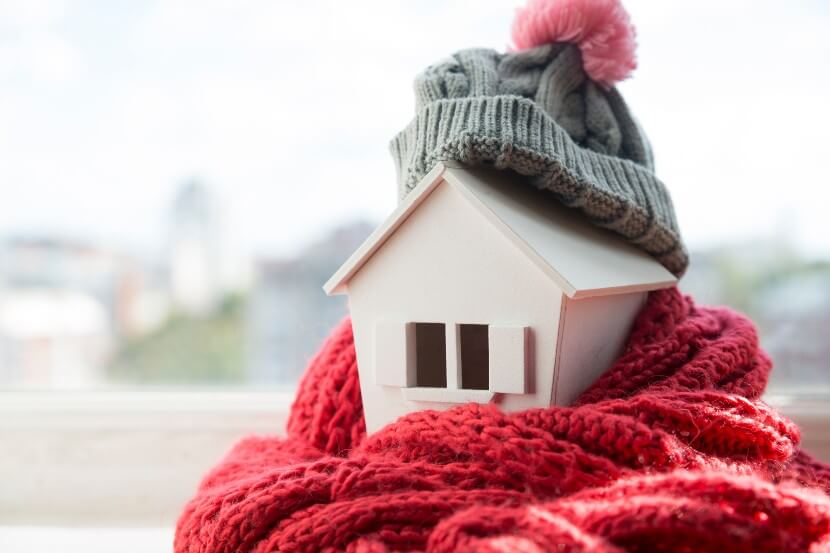 House wrapped in scarf and woolly hat