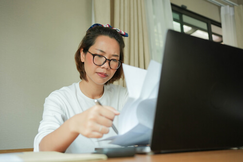 Woman frowning at energy bill
