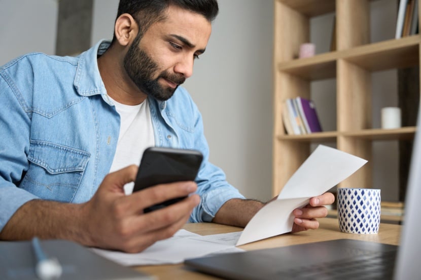 man looking at phone bill