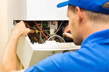 Engineer servicing a boiler