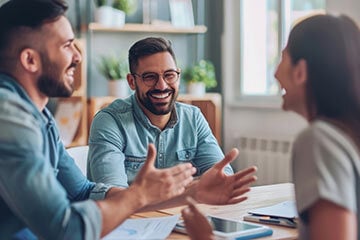 A group of three chatting together at a table