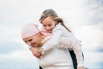 A mother with cancer enjoying time with her child