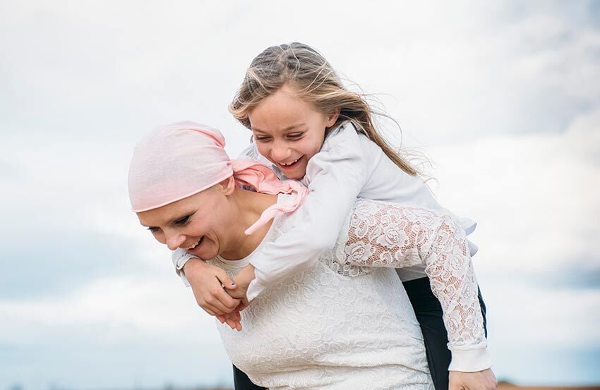A mother with cancer enjoying time with her child