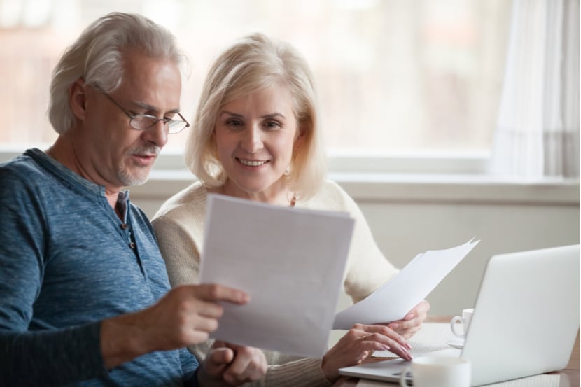 A couple reading life insurance papers deciding what type of cover to choose