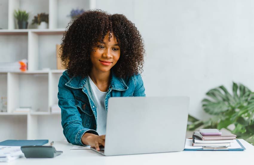 Woman using a laptop at a desk