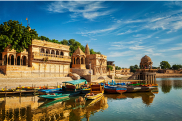 A lake with boats on it in Jaisalmer, Rajasthan, India