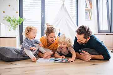 Happy family smiling together, representing the importance of life insurance