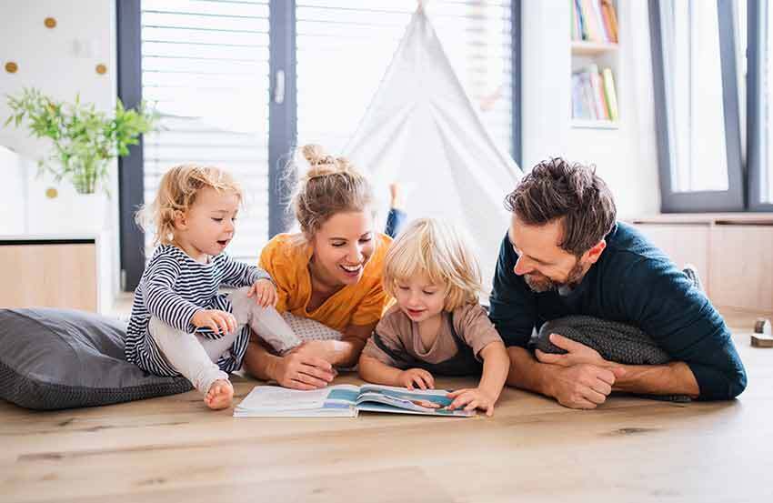 Happy family smiling together, representing the importance of life insurance