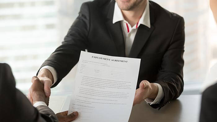 Person shaking hands with someone at a job interview