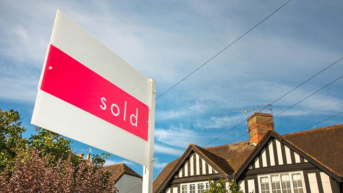 A Tudor house with a sol sign outside