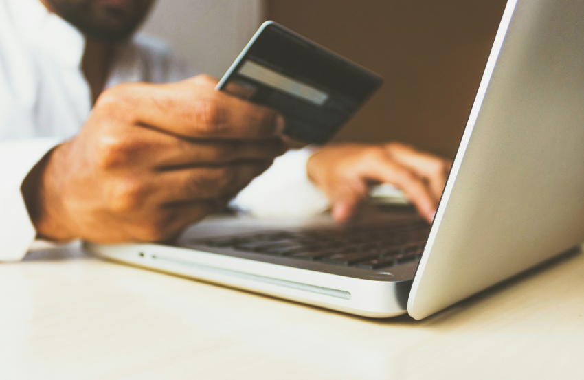 person using credit card for online purchase