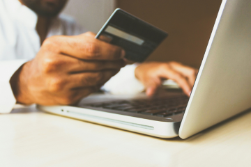 person using credit card for online purchase
