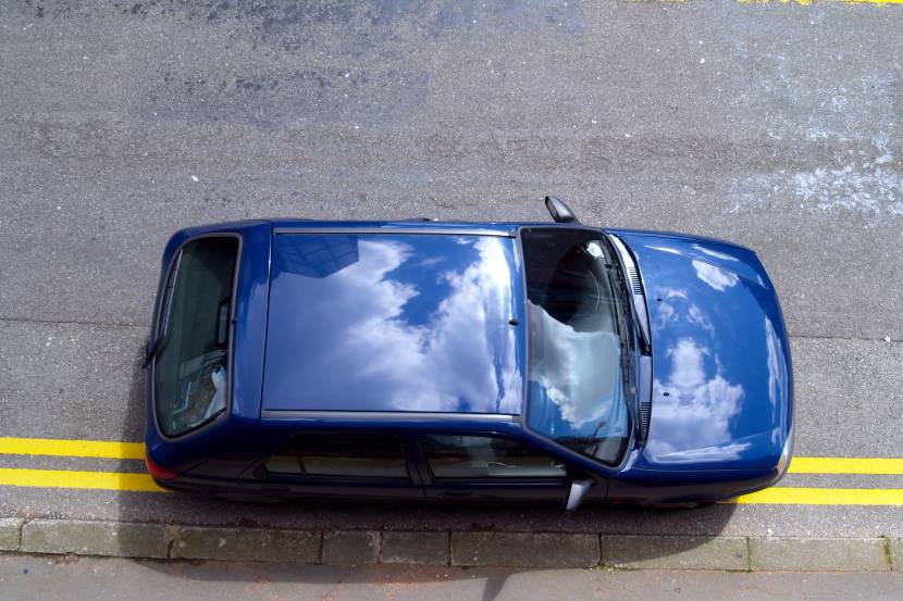 Blue car parked on double yellows
