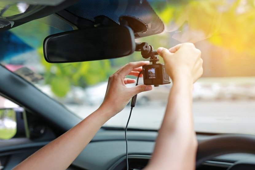 Person adjusting dash cam 