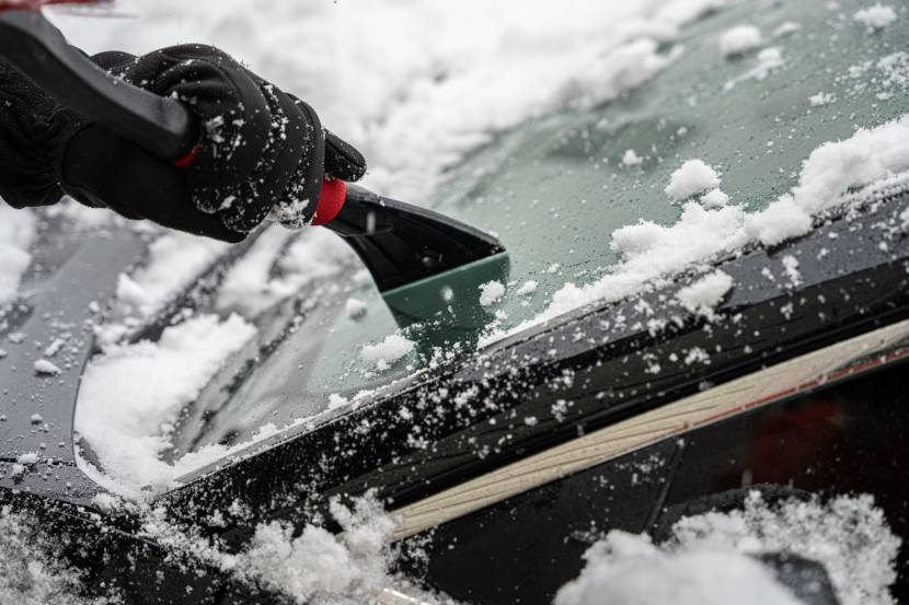 Person de-icing car