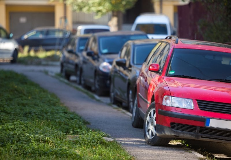 A car parks on the pavement