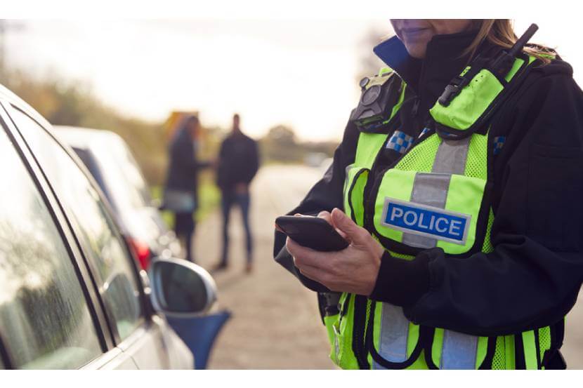 Police officer issuing a fine to a driver