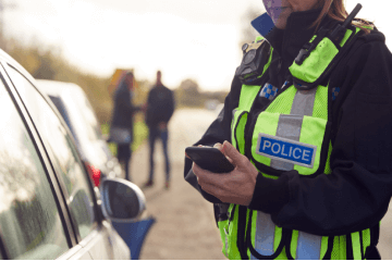 Police officer issuing a fine to a driver