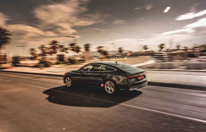 Audi A7 driving through Malaga port street, with fast motion effect