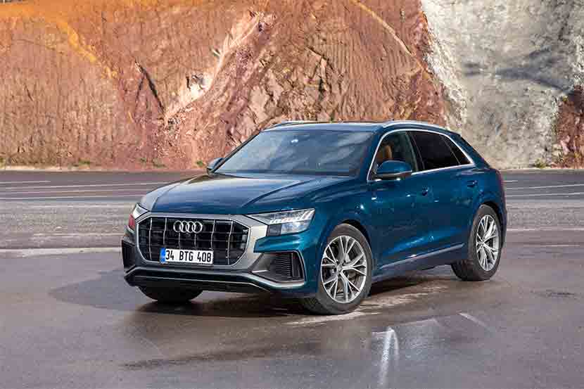 Blue Audi Q8 against clay backdrop