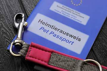 A blue European pet passport with a red dog lead