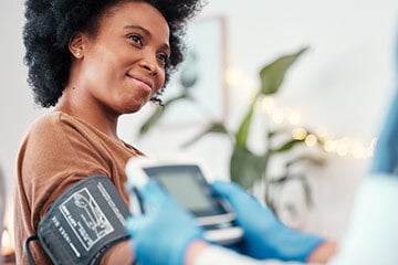 Lady having her blood pressure taken by a doctor