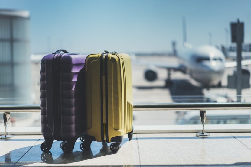 Suitcases with plane behind