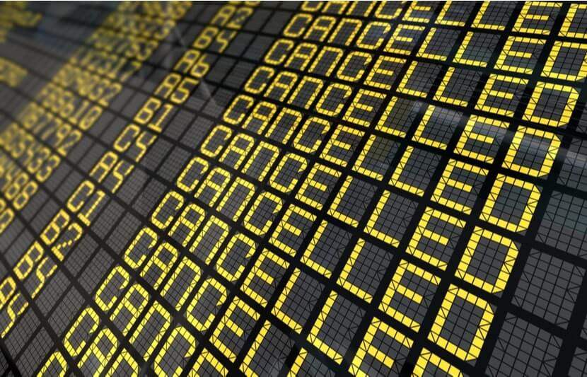 A flight board with a list of cancelled flights
