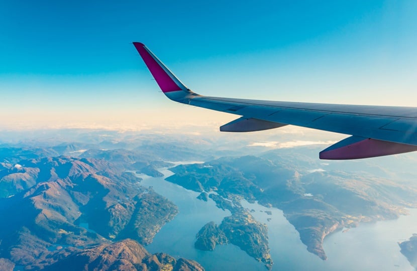 aeroplane flying over mountains and the sea