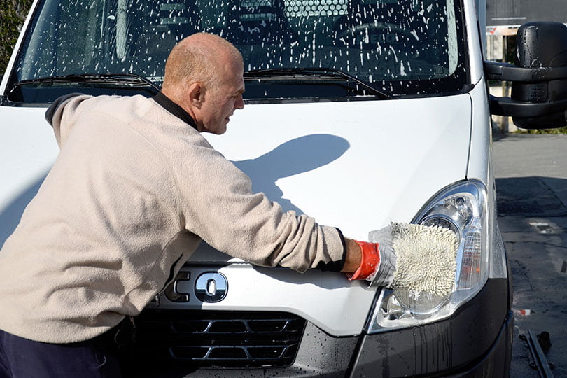 Cleaning a van with a wash mitt