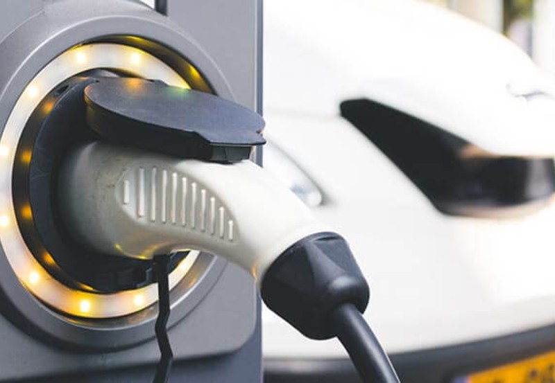 An electric van plugged into a charger