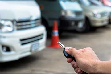 Person locking a van with a key fob