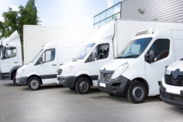 A row of sparkly white vans of all different body types