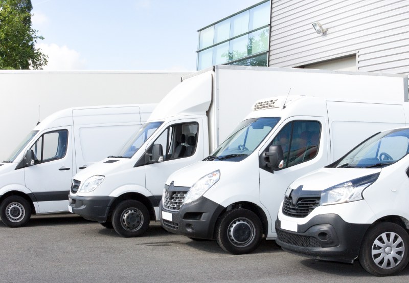 Vans with different body types parked together