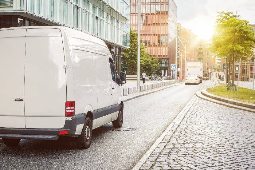 A white van parked up on a road