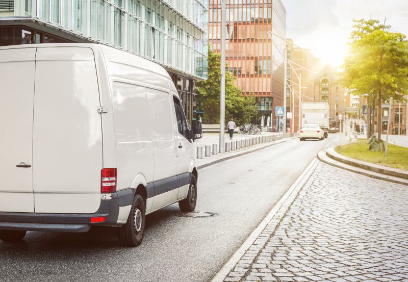 A white van parked up on a road
