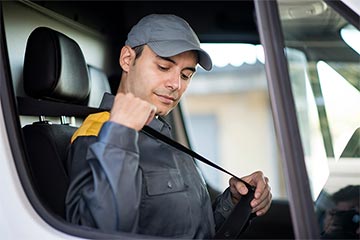 Van driver putting their seatbelt on