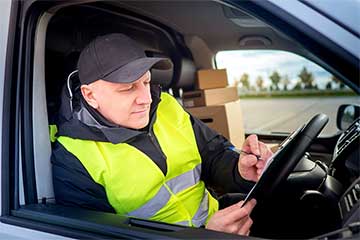 Person with a high vis vest sat in a van