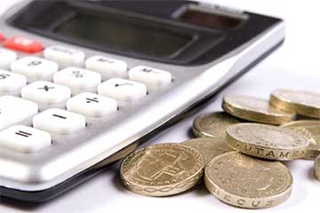 Close up of a calculator and some one pound coins
